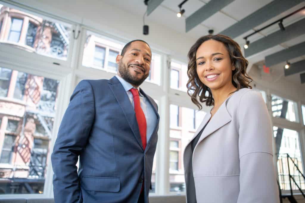 man-and-woman-smiling-inside-building