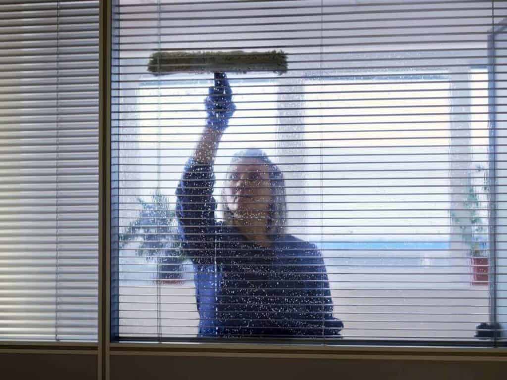 A office manager is cleaning her office during COVID-19