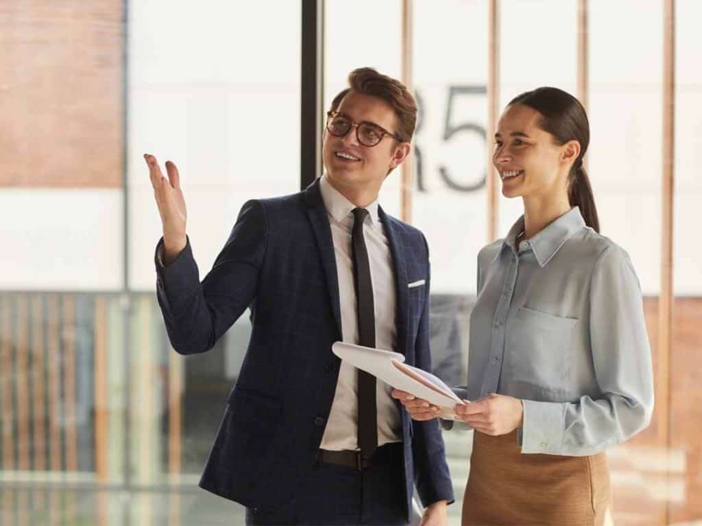 a man and a woman having a meeting about property management companies