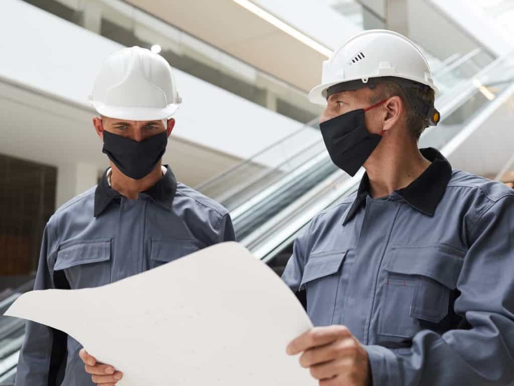 Commercial Construction Workers looking over blueprints for a project