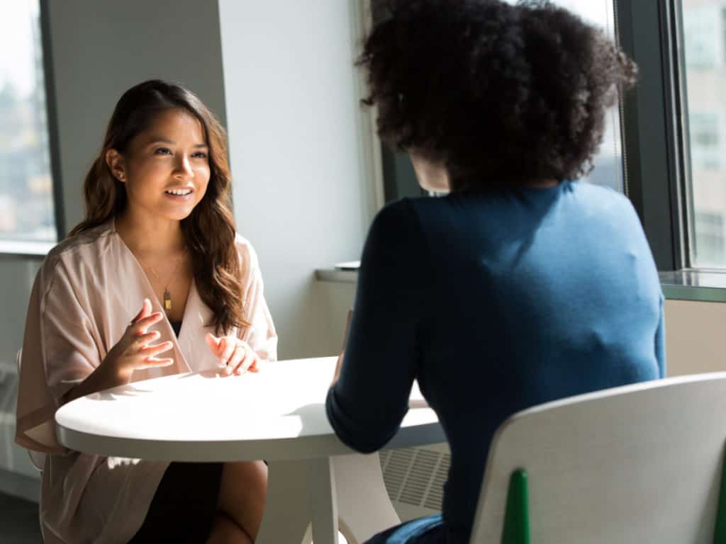 women talking at work in a workplace with diversity