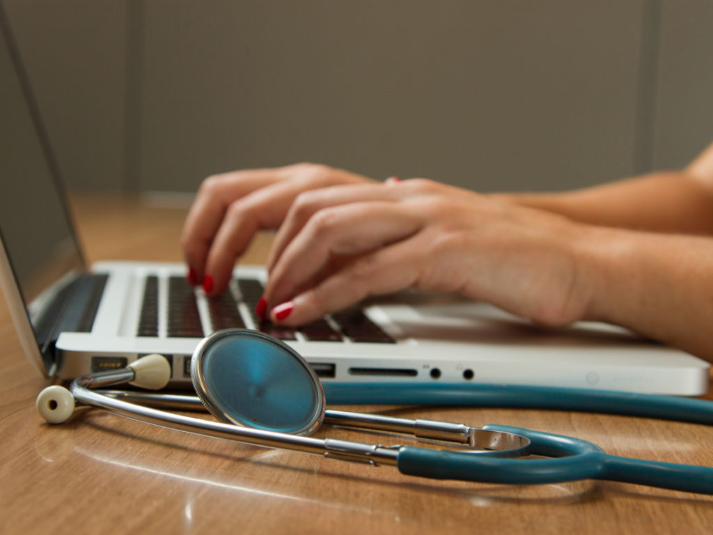 doctor working on laptop in a medical office building