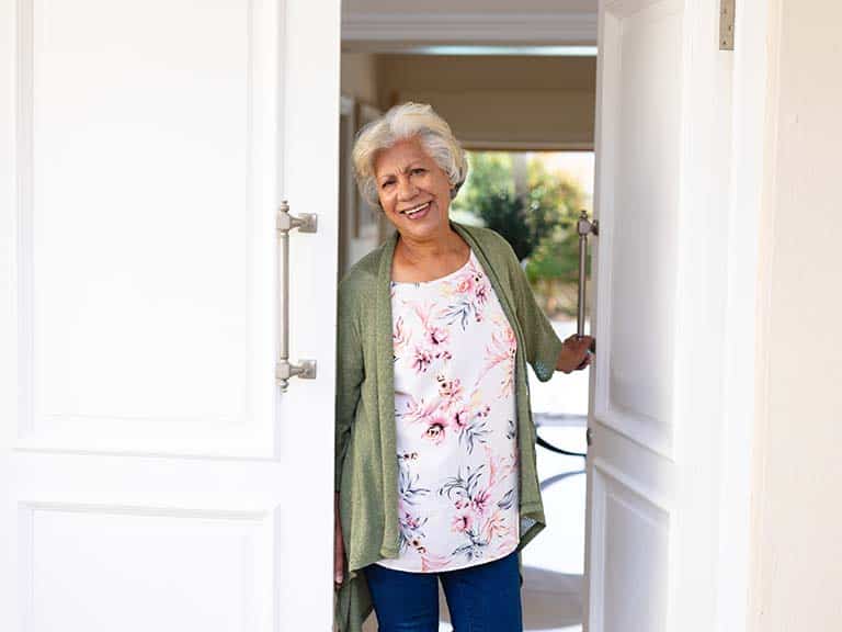 woman at the door in senior living facility