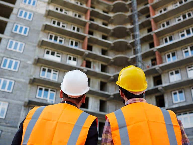 construction workers looking at a building commercial adaptive reuse