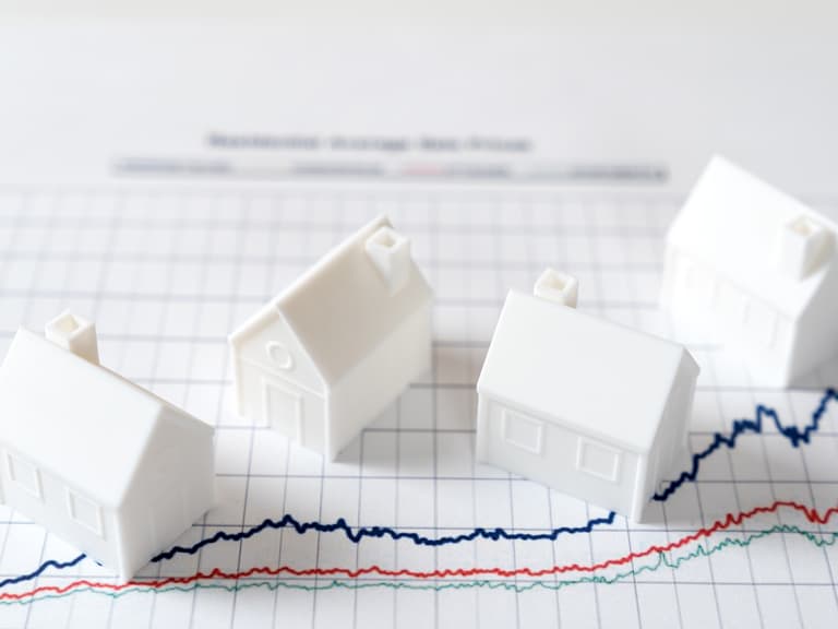 Model houses on a graph representing the commercial real estate market